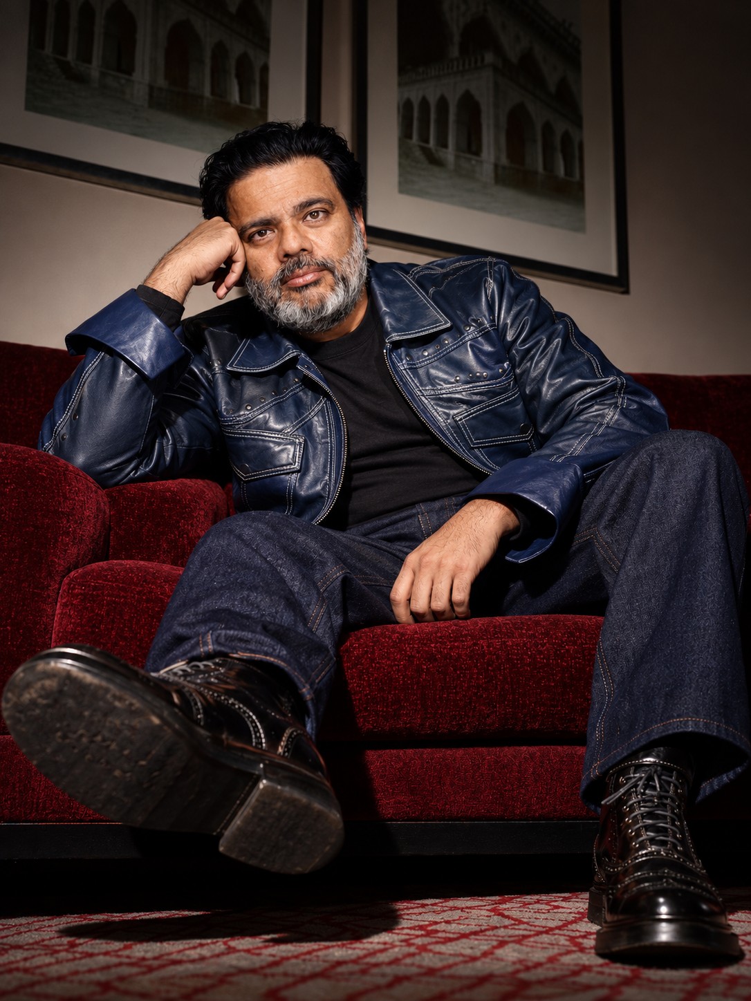 Sunil seated in a red armchair