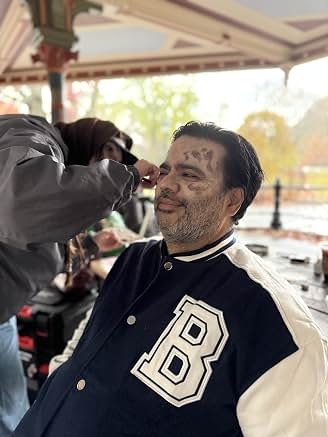 Sunil in a varsity jacket on set