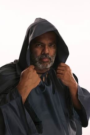 Sunil in character wearing a dark hood