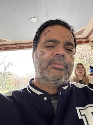 Sunil wearing a varsity jacket on location