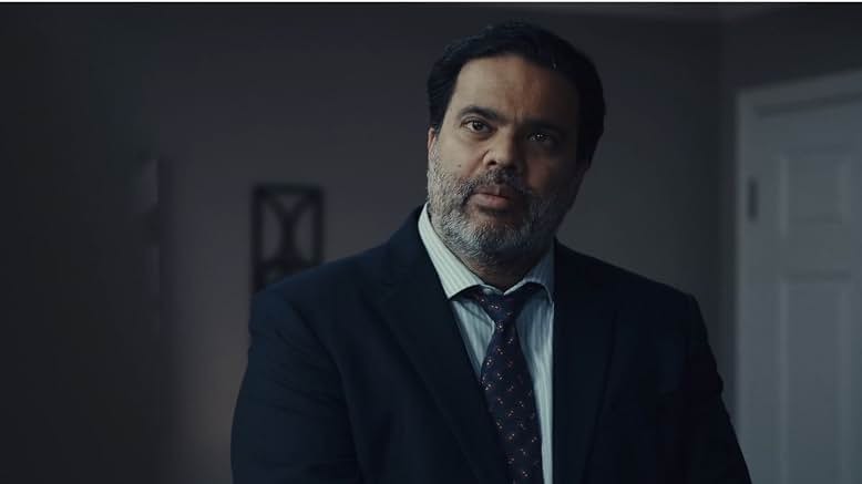 Sunil performing a dramatic scene in a suit
