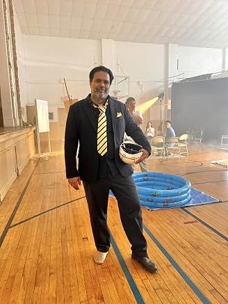 Sunil on a studio set in formal attire