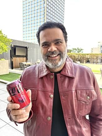 Sunil in a red jacket on location