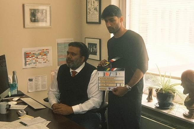 Sunil and a crew member preparing a scene