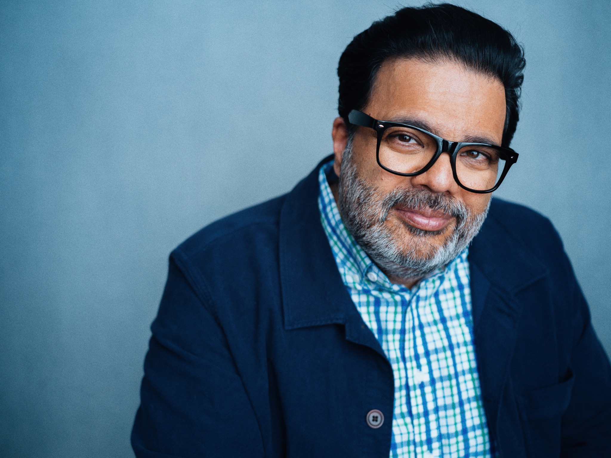 Sunil Saxena wearing glasses and a navy jacket